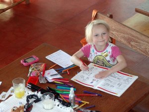 Lara working on her Maths workbook at beachhouse