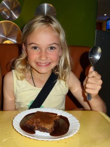 Zoe eating a brownie in a Kilo restaurant