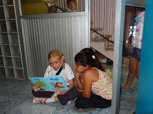 Zoe reads 'Up' to some girls at the English Centre