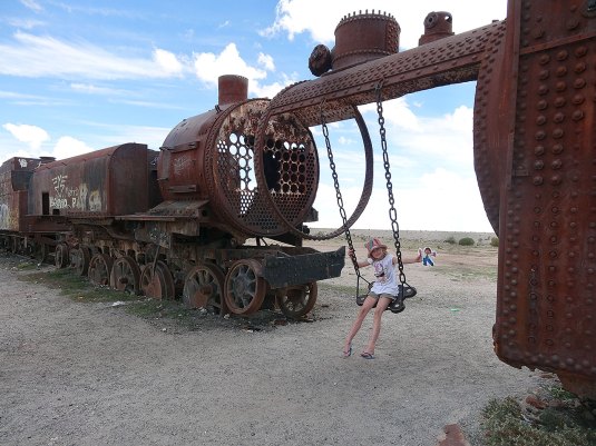 Flat Stanley and me on the swing at the train cemetary near Uyuni, Bolivia