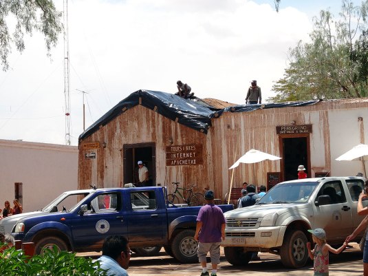 This building in town was white yesterday now they are mending the roof like nearly every place in town! They told us it will rain again even harder today!  