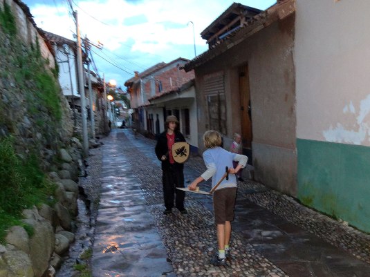 Miro and me sword fighting in the street with his swords and shields.